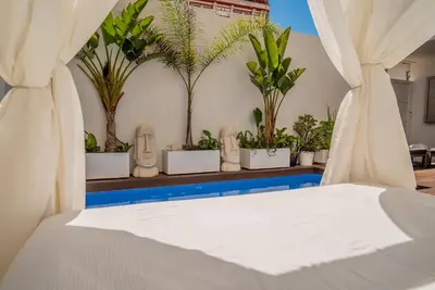 a bed in a room with potted plants at VLVilla - Villa de lujo en Valencia con piscina privada y sala de cine in Burjasot