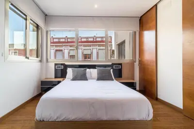 a bedroom with a large white bed with two pillows at VLVilla - Villa de lujo en Valencia con piscina privada y sala de cine in Burjasot