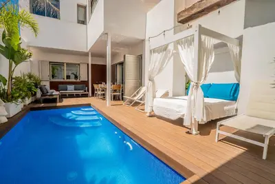 a bedroom with a bed and a swimming pool at VLVilla - Villa de lujo en Valencia con piscina privada y sala de cine in Burjasot