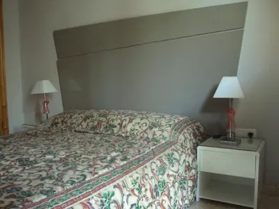 a bedroom with a bed and two lamps on a nightstand at Mirant el Mar in Port Saplaya