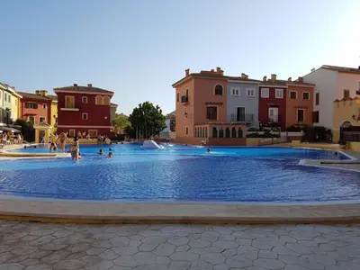 a large swimming pool with people in the water at Mirant el Mar in Port Saplaya