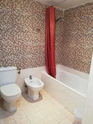 a bathroom with a toilet and a sink and a tub at La Vista al mar de Belén in Port Saplaya
