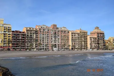 a view of a beach with tall buildings at La Vista al mar de Belén in Port Saplaya