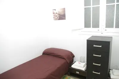 a bedroom with a bed and a dresser and a window at Carlos & Ana Amplio Apartamento 4 Habitaciones Centro Valencia in Valencia