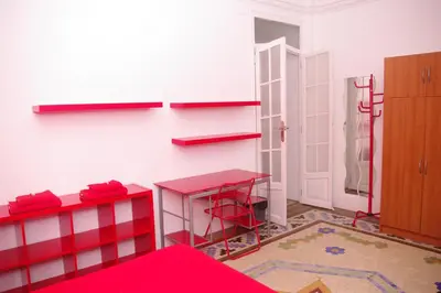 a room with a red table and a red stool at Carlos & Ana Amplio Apartamento 4 Habitaciones Centro Valencia in Valencia