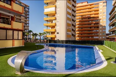 a swimming pool in the middle of some apartment buildings at Apartamento con Vista al Mar in Tavernes de Valldigna