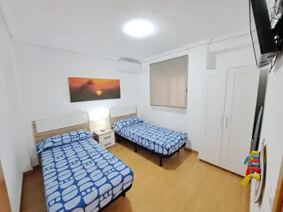 a room with two beds in a room at Céntrico apartamento en Valencia próximo parada de metro Ángel Guimerà in Valencia