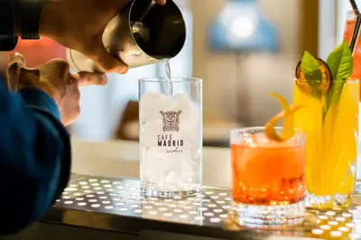 a person pouring a drink into a glass at MYR Marqués House in Valencia