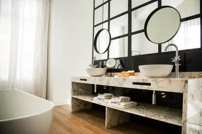 a bathroom with two sinks and a tub and a mirror at MYR Marqués House in Valencia