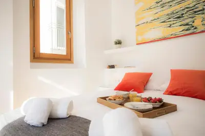 a room with a bed with a tray of fruit on it at Balcón de Manet in Valencia
