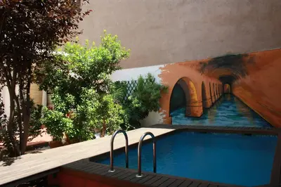a swimming pool with a painting on the side of a building at B&B 