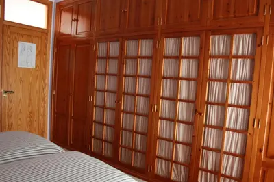 a bedroom with wooden cabinets and a bed in it at B&B 