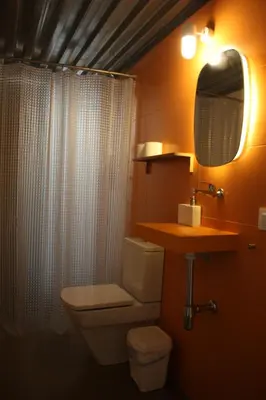a bathroom with a toilet and a sink and a mirror at B&B 