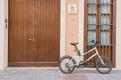 a bike parked in front of a wooden door at Barracart Apartments in Valencia