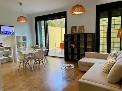 a living room with a couch and a table at La casita de Palomar - PalomarGroup in Valencia