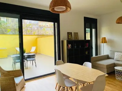 a living room with a table and a couch at La casita de Palomar - PalomarGroup in Valencia