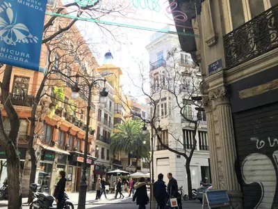 a group of people walking down a city street at Sun Studio Valencia in Valencia