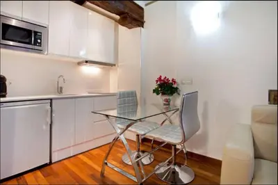 a kitchen with a glass table and two chairs at Sun Studio Valencia in Valencia