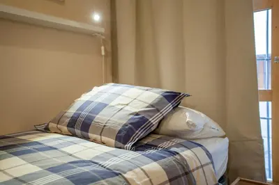 a bed with pillows on top of it in a room at Apartamento Fos in Valencia
