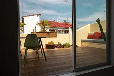 a view of a balcony with a table and a chair at SingularStays Ático Roger de Flor in Valencia