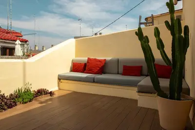 a couch sitting on a balcony with a cactus at SingularStays Ático Roger de Flor in Valencia