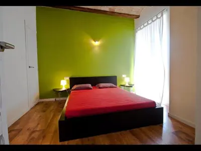 a green bedroom with a bed with a red blanket at Calatrava in Valencia