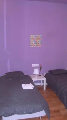 a bedroom with two beds and a purple wall at Calatrava in Valencia
