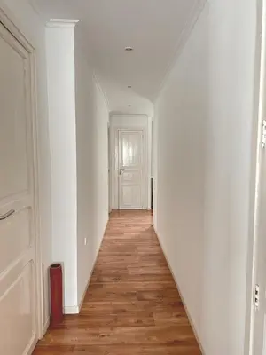 an empty hallway with white walls and a wooden floor at Calatrava in Valencia