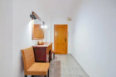 a kitchen with a table and chairs and a wooden door at Cisneros flat in Valencia