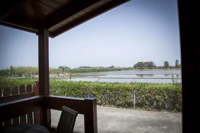 a view of a river from the porch of a house at Devesa Gardens in El Saler