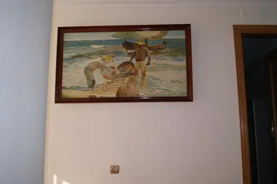 a painting of people in the water on a wall at Casa Pescadores de Vallterra in El Palmar