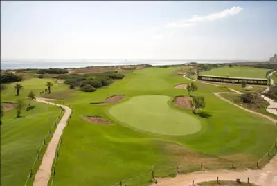 an overhead view of a golf course with the ocean at Casa Pescadores de Vallterra in El Palmar