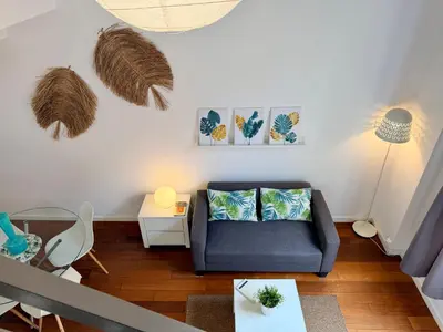 a living room with a blue couch and a table at Petit Palomar - PalomarGroup in Valencia