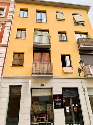 a yellow building with windows and balconies on it at Petit Palomar - PalomarGroup in Valencia