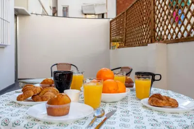 a table with plates of pastries and glasses of orange juice at Apartment City of Arts and Sciences 1 in Valencia