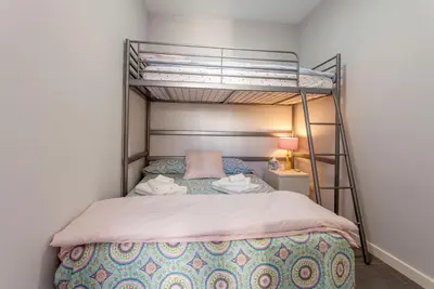 a bedroom with a bunk bed with a ladder at Apartment City of Arts and Sciences 1 in Valencia