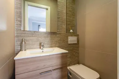 a bathroom with a sink and a toilet and a mirror at Apartment City of Arts and Sciences 1 in Valencia
