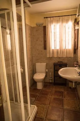 a bathroom with a toilet and a sink at Cases Rurals El Castell in Torres-Torres
