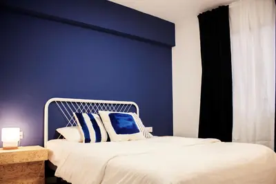 a blue bedroom with a bed with a blue wall at B&B El Mercat in Valencia