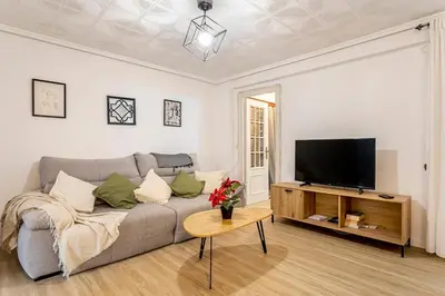 a living room with a couch and a tv at Big apartment at beach with terrace in Valencia