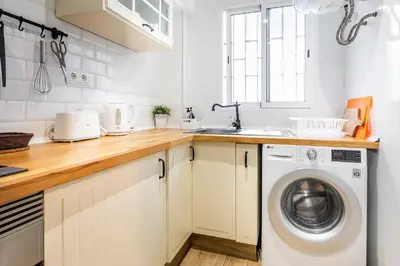 a kitchen with a washing machine and a sink at Big apartment at beach with terrace in Valencia