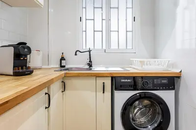 a kitchen with a washing machine and a sink at Big apartment at beach with terrace in Valencia