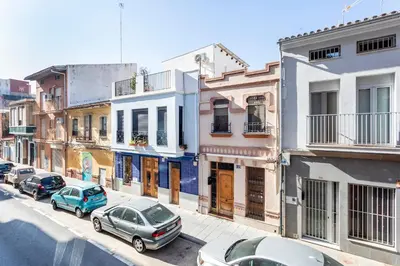 a group of cars parked on a street with buildings at Big apartment at beach with terrace in Valencia