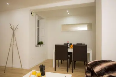 a dining room with a table and black chairs at El Micalet Apartment in Valencia