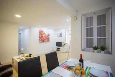 a living room with a table and a dining room at El Micalet Apartment in Valencia