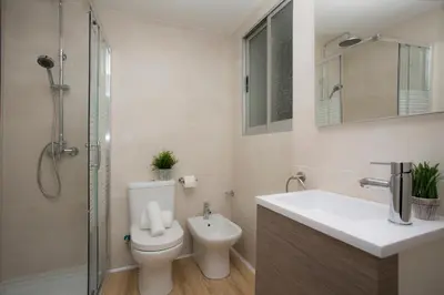 a bathroom with a toilet and a sink and a shower at El Micalet Apartment in Valencia