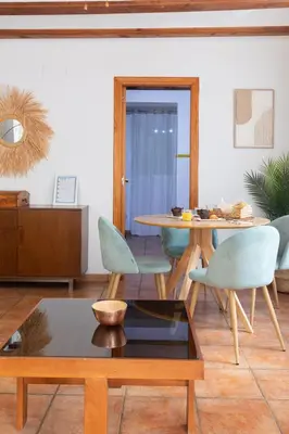 a living room with a table and chairs at Travel Habitat Plaza del Pilar. in Valencia