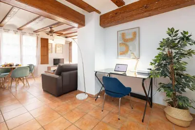 a living room with a table and chairs and a couch at Travel Habitat Plaza del Pilar. in Valencia