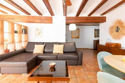 a living room with a leather couch and a table at Travel Habitat Plaza del Pilar. in Valencia