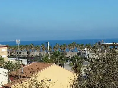 a view of a city with palm trees and the ocean at APARTMENTSUITESPAIN Beach Economy in Valencia